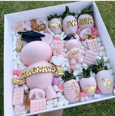 a box filled with pink and gold graduation decorations