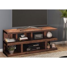 an entertainment center with a flat screen tv mounted on it's side, in a living room