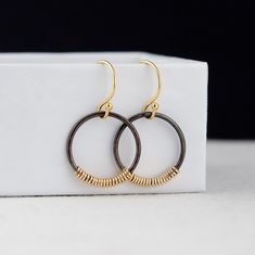 This unique pair of Black and Gold Circle Earrings are handcrafted for you with great care. Hand-hammered oxidized silver rings and 14K gold-filled wire make each pair one of a kind. The earrings are classic and comfortable. Perfect earrings for every day. Two metals combination creates a very beautiful and unique contrast. MATERIALS AND SIZE ◆ Metal - 14K Gold Filled, 925 Sterling Silver  ◆ Earrings measure 24 mm / 0.94 inches from the top of the ear wire ◆ All earrings with French ear wires co Black Brass Hoop Earrings As Gift, Hand Forged Black Earrings For A Gift, Hand Forged Black Earrings As A Gift, Black Hand Forged Brass Earrings, Artisan Small Hoop Earrings For Everyday, Artisan Black Earrings As Gift, Artisan Black Earrings For Gift, Black Hand Forged Dangle Jewelry, Hand Forged Black Brass Earrings