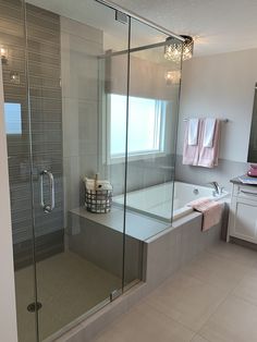 a bathroom with a large glass shower door