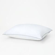 a white pillow sitting on top of a white floor