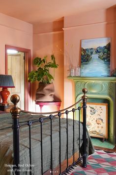 a bed room with a neatly made bed and a potted plant on the nightstand