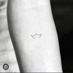 a person with a small tattoo on their arm