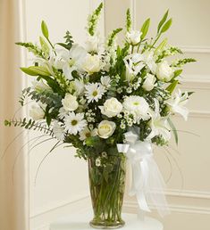 a vase filled with white flowers on top of a table