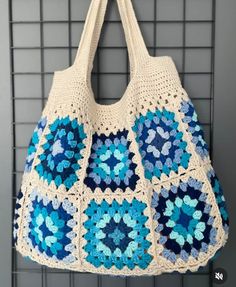 a crocheted bag hanging on a wall