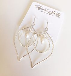 Mini lotus shaped double hoops earring with creamy white color fresh water pearls. White pearls are 8-9mm in size. Dainty hoops were hand shaped using round wire and hammered for texture and shine. Handmade French ear wires. Earrings's total length is about 2 inches. Silver Teardrop Hoop Earrings With Pearl Charm, White Pearl Hoop Earrings For Anniversary, Silver Teardrop Pearl Hoop Earrings, Nickel-free Teardrop Pearl Earrings, Nickel Free Teardrop Pearl Earrings For Anniversary, Nickel-free Teardrop Pearl Earrings For Anniversary, Nickel-free White Hoop Pearl Earrings, White Teardrop Hoop Earrings Nickel Free, Delicate Silver Teardrop Pearl Earrings