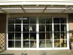 the front entrance to a building with glass doors