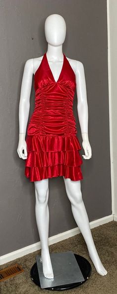 Deadstock Vintage 1990's Halter Mini-Dress from XOXO Collection, size Large tag (please see measurements for best fit). New with all original sales tags attached. Red slinky Satin polyester fabric. Lined at bust and Bodice in red soft polyester fabric. Pull on style. Three ruffle skirt. Ruched on entire bodice. Soft triangle cups with long tie at neck. Thick enough fabric this is not See-through. In great condition, no major flaws found. Shown clipped on size 4/6 mannequin. Measurements taken la Halter Neck Red Dress, Halter Mini Dress, Cherry Pie, Red Satin, Ruffle Skirt, Dress Clothes For Women, Red Dress, Favorite Outfit, Bodice