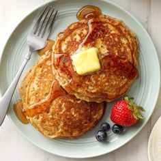 pancakes with butter and blueberries on a plate