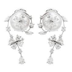 Presented by the acclaimed Designer Stefan Hefner, we are delighted to offer these exquisite and delicate Estate Earrings showcasing lustrous pearls adorned with brilliant diamonds.A floral motif, with movable flower accents - crafted in 18K White Gold and Italian made.Anchored with a pair of 12 mm high luster, fine quality, soft silver South Sea pearls. Surrounding each pearl are (14) round brilliant-cut diamonds, (18) pear-cut diamonds, and (4) marquise-cut diamonds, all prong-set.The total di Pearl Jewels, Golden South Sea Pearls, Jewelry Appraisal, Pearl And Diamond Earrings, Sea Pearl, Earring Display, Emerald Earrings, Sea Pearls, South Sea Pearls