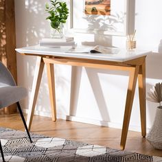 a desk with a chair and potted plant on it