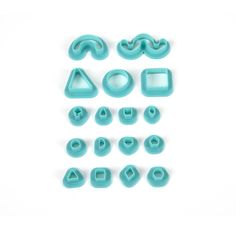 various shapes and sizes of cookie cutters on a white surface