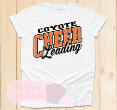 a t - shirt with the words coyote cheer leading on it's front and back