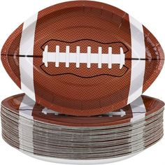 a football paper plate on top of stacks of plates