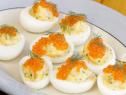 deviled eggs topped with red cavia and dill