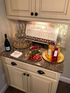 a kitchen counter topped with lots of food and drinks