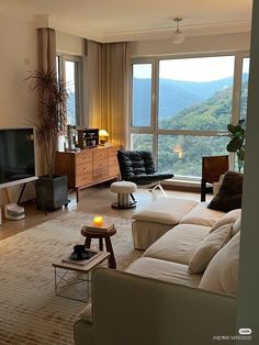 a living room filled with furniture and a flat screen tv