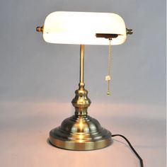 a lamp that is sitting on top of a table with a cord attached to it