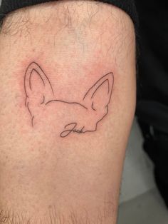 a man's leg with a small tattoo of a fox on the lower thigh