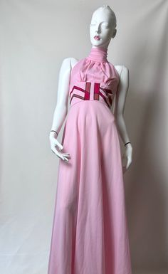 Vintage 70s Pink Polyester High Neck Halter Gown A Line Maxi Dress Fitted Bust Wide Suede Appliqué Panel Open Back. Super Fun Vintage 70s Pink Polyester Maxi Gown. Flash Back To The 70s. This Beauty Features A Perfectly Pink Polyester Fabric Done In An A Line Silhouette. It Has A High Halter Neckline With Some Gathering On Back Fastened With Hook And Thread Eye At Neck. The Bodice Is Fitted With Some Pleating Extending From A Wide Panel Waistband. The Wide Waistband Is Unique As It Has Mauve And Pink Geometric Suede Or Faux Suede Appliqués Edged With Contrasting Black Stitching; The Design Pops. The Back Has An Open Cut Design Extending From The Top Of The Wide Waistband With Back Zipper Closure. A Bold Look That Is Eye Catching. A Statement Making Dress. Who Doesn't Love Pink. Unlined Siz Vintage A-line Maxi Dress For Evening, Retro Sleeveless Evening Midi Dress, Retro Sleeveless Midi Dress For Evening, Vintage Fitted Halter Neck Dress, Fitted Maxi Dress For Vintage Events, Vintage Pink Midi Dress For Party, 1970s Fitted Maxi Length Vintage Dress, Fitted Retro Maxi Length Vintage Dress, Retro Floor-length Dresses For Vintage Fashion