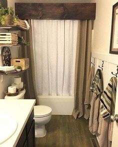 a bathroom with wood flooring and white walls