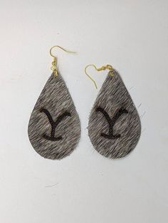 This is a handmade product with genuine hair-on cowhide. I personally add the brand with a laser engraver, and I am able to customize earrings and any other product with your personal brand!