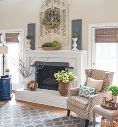 a living room filled with furniture and a fire place in front of a mirror on the wall