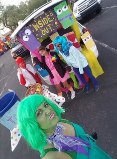 a group of people dressed in costumes on the street