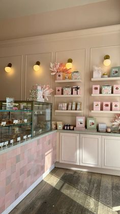 the inside of a pastry shop with pink and white decor