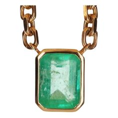 A spectacular unisex emerald solitaire necklace. The featured stone is 7.61-carats, emerald cut. The emerald has a beautiful medium green color, with very good luster and minor imperfections. This large beauty is set in a bezel-set, 14K yellow gold setting. The chain is solid gold and is 22.5 inches total with two stoppers so the necklace can be worn at shorter lengths. Setting Style: Bezel - Solitaire Setting Material: 14K Yellow Gold Weight: 61 Grams Main Stone: Colombian Emerald Shape: Emeral