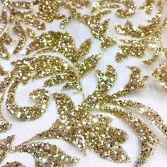 gold and silver sequins on white fabric