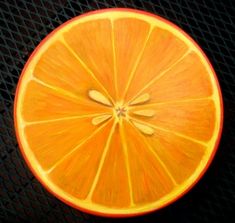 an orange cut in half sitting on top of a table