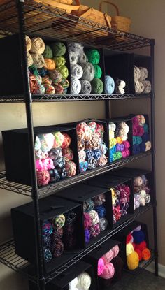 the shelves are filled with yarn and crochet hooks