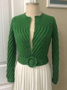 a woman's green cardigan sweater on a mannequin