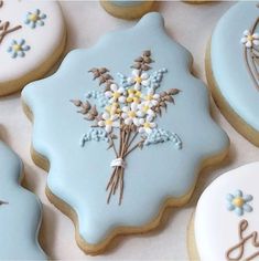 decorated cookies with frosting and flowers on them