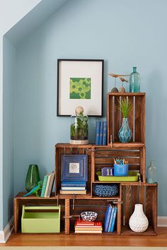 the shelves are filled with books, vases and other decorative items in this room