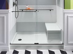 a bathroom with a black and white checkered floor, shower head, and toilet