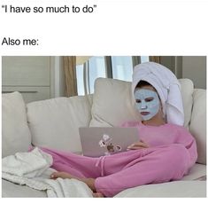 a woman in pink is sitting on a couch with a white sheet covering her face