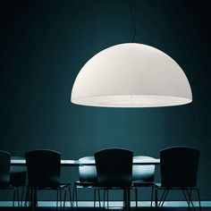 a table with chairs and a lamp hanging over it