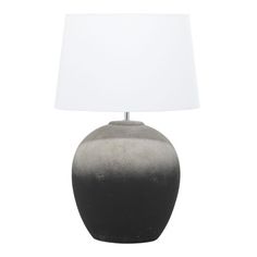 a black and white table lamp with a white shade on the top, against a white background