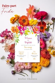 the wedding card is surrounded by colorful flowers