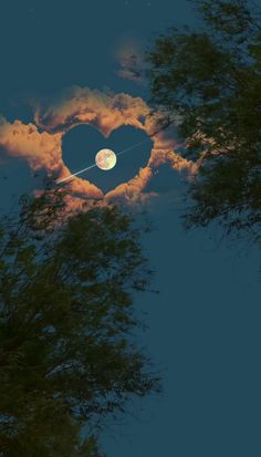 a heart shaped cloud with the moon in the background