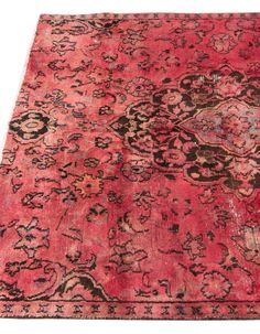 an antique rug with red and black colors