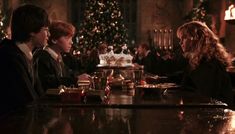 three people sitting at a bar in harry potter's hogwarts movie scene