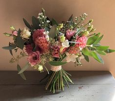 a bouquet of flowers sitting on top of a table