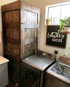 a washer and dryer sitting next to each other in a room with wooden doors