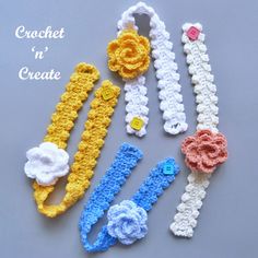 four crocheted hair clips with flowers and buttons on the ends, all in different colors