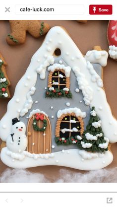 a gingerbread house decorated with icing and decorations