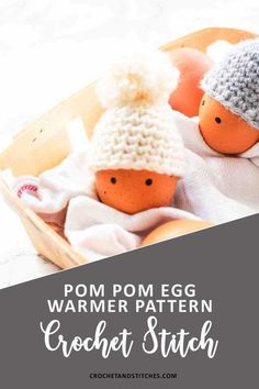 two knitted eggs in a basket with text overlay that reads pom pom egg warmer pattern crochet stitch