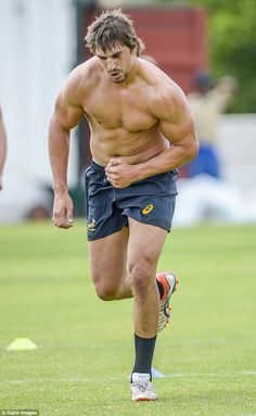 a shirtless man is running on the field